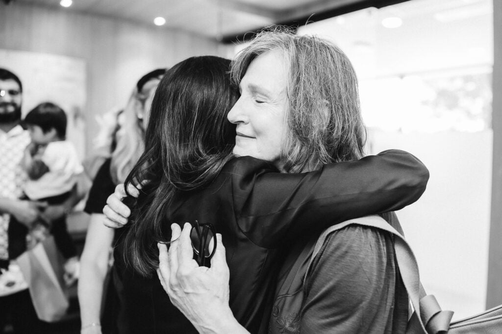 Founder and Chief Executive Officer Dr. Anna Le, FACOG, embraces a patient during the grand opening of the Reston Anna Health Center at the newly unveiled Anna Health building, formerly the American Center of Radiology.